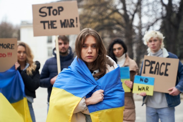 group of young caucasian people manifesting against war in ukraine